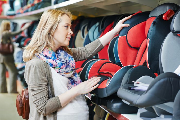 Best Convertible Car Seats 2023 - Image of a Mother Choosing a Convertible Car Seat in a Store.